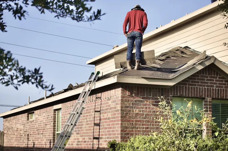 Professional roofer working on a residential roof in Sulphur Springs